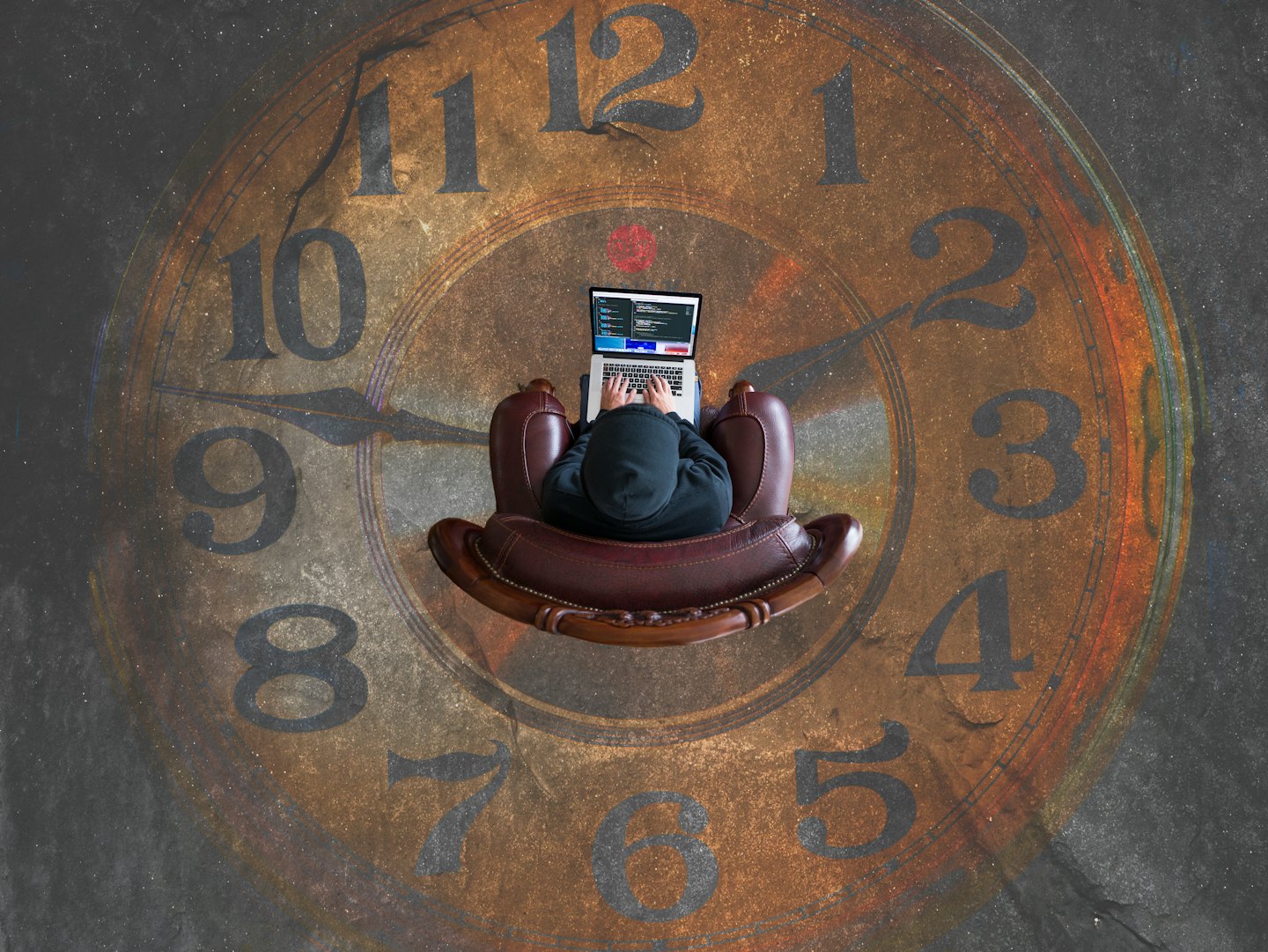 AGWAT person typing on a laptop over a faded vintage clock face, symbolizing productivity, time management, and focus.